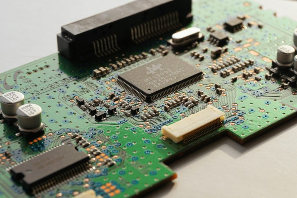 Detailed close-up photo of a circuit board highlighting microchip components and electronic circuits.