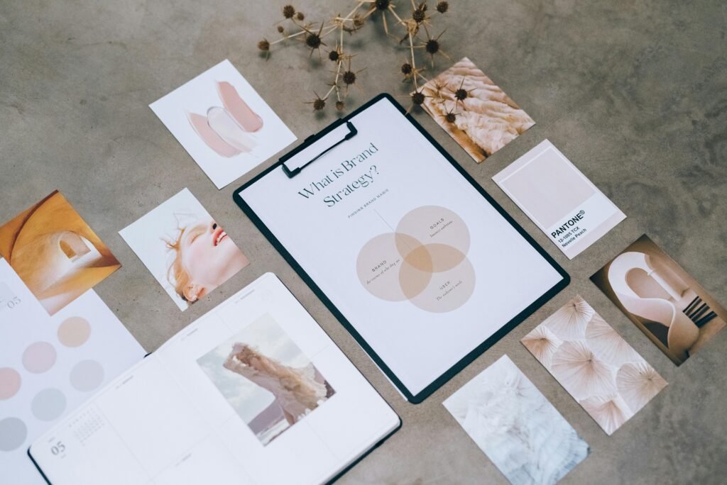 Flat lay of a minimalist brand strategy moodboard on a concrete surface.