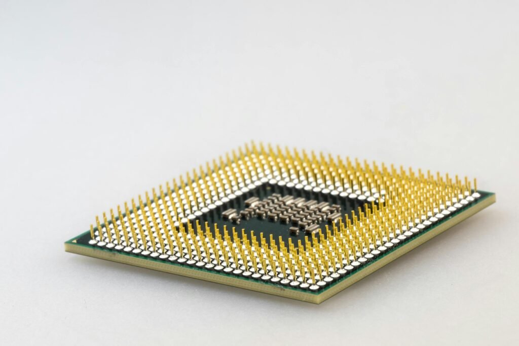 A detailed close-up of a CPU microchip showcasing its intricate gold pins and technology.